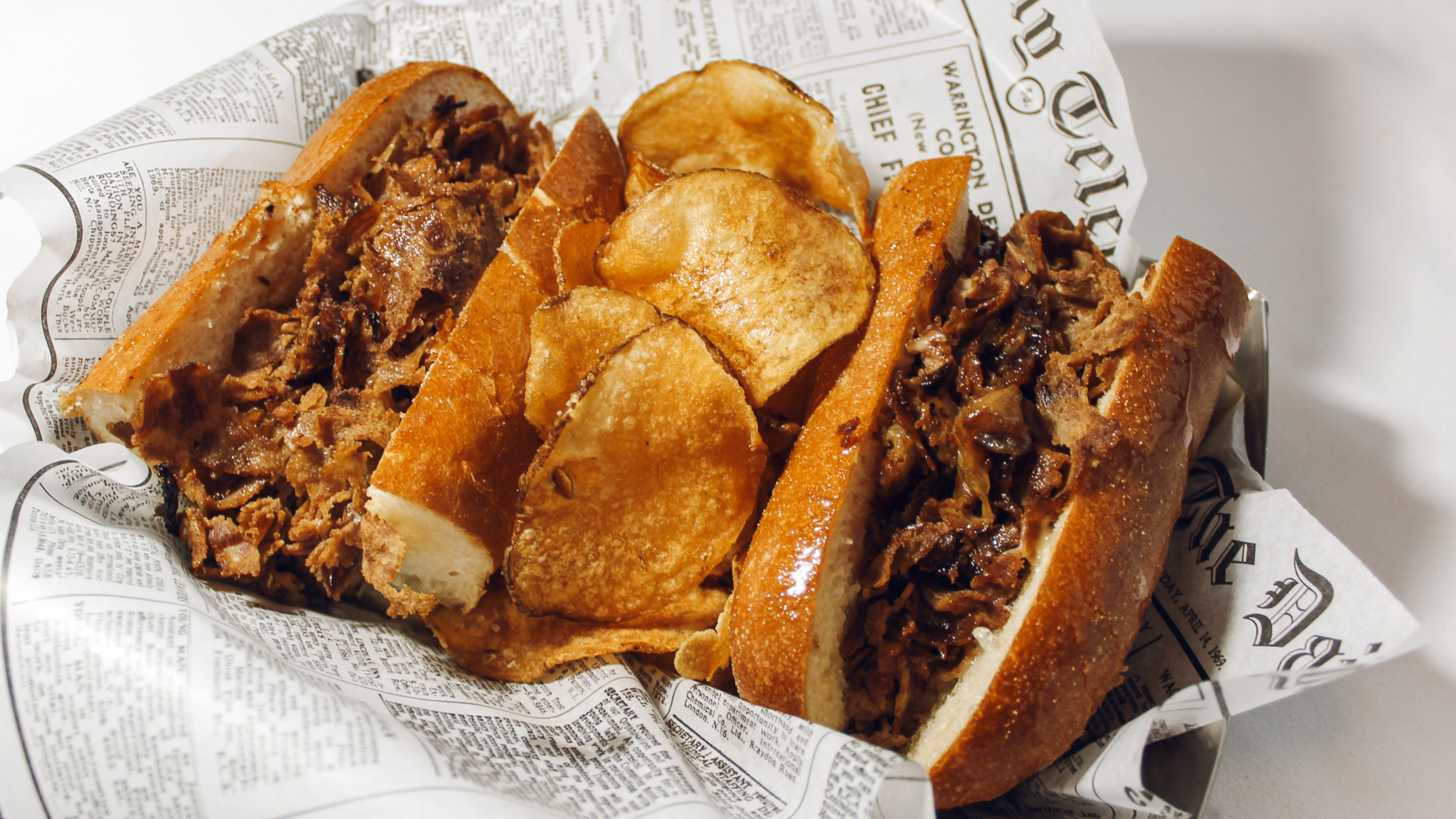 cheesesteak in newspaper basket