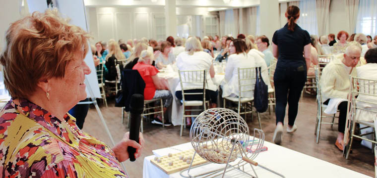 a woman standing in front of a crowd of people