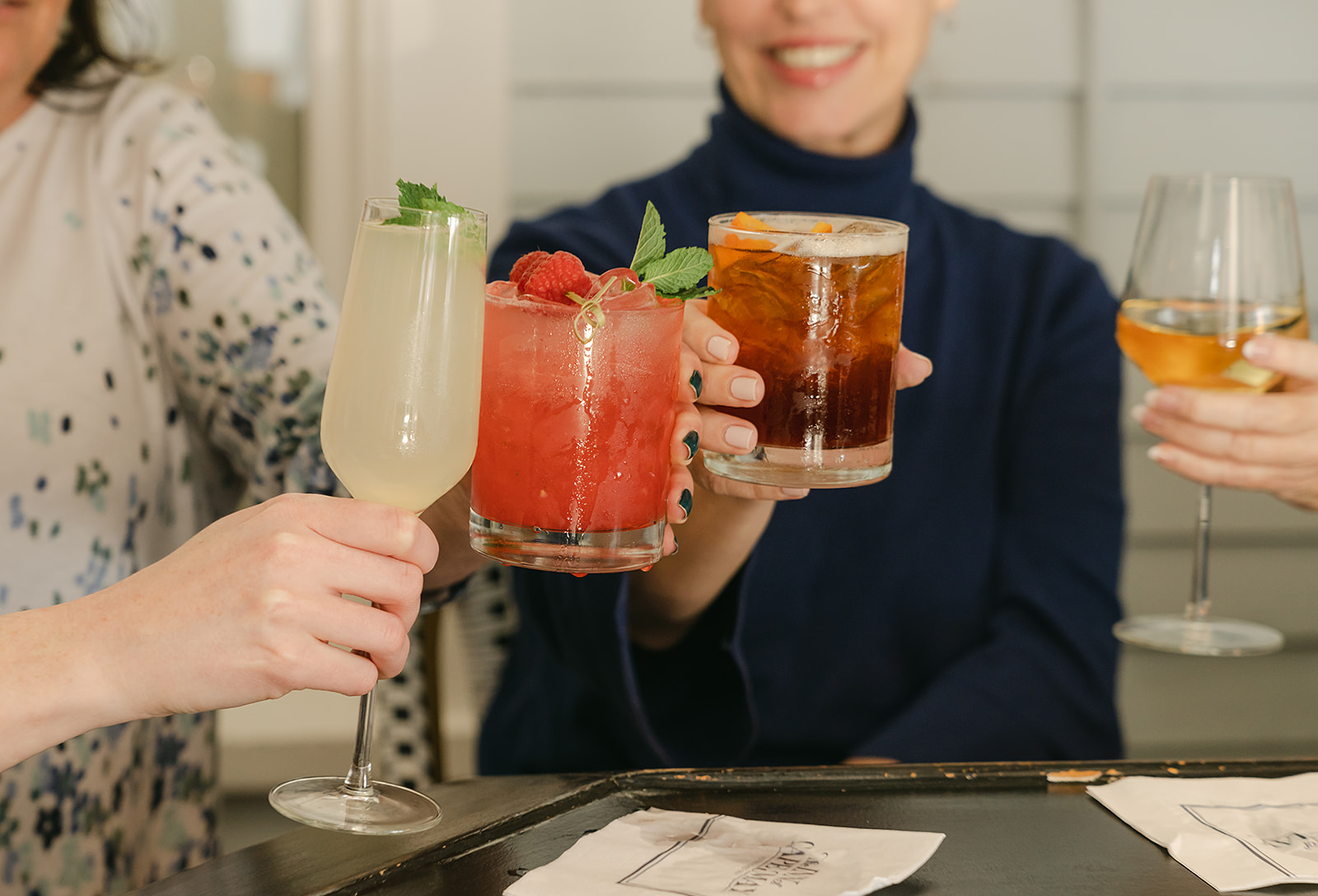 a group of people holding up glasses of drinks