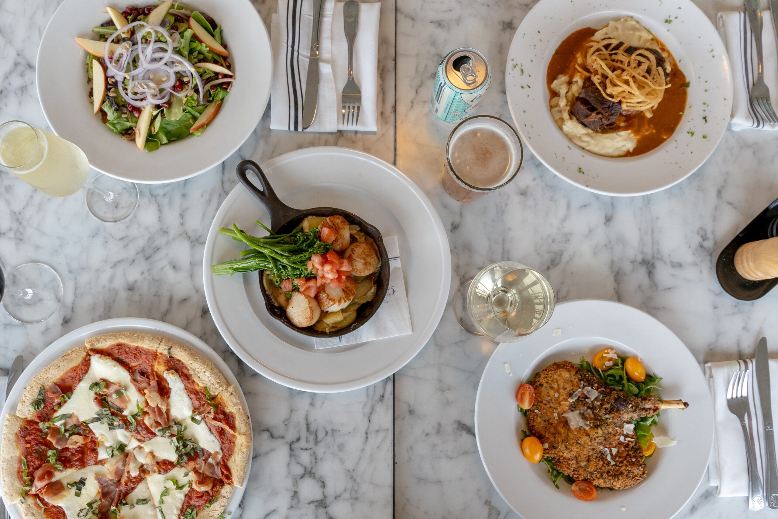 a table topped with plates and bowls of food